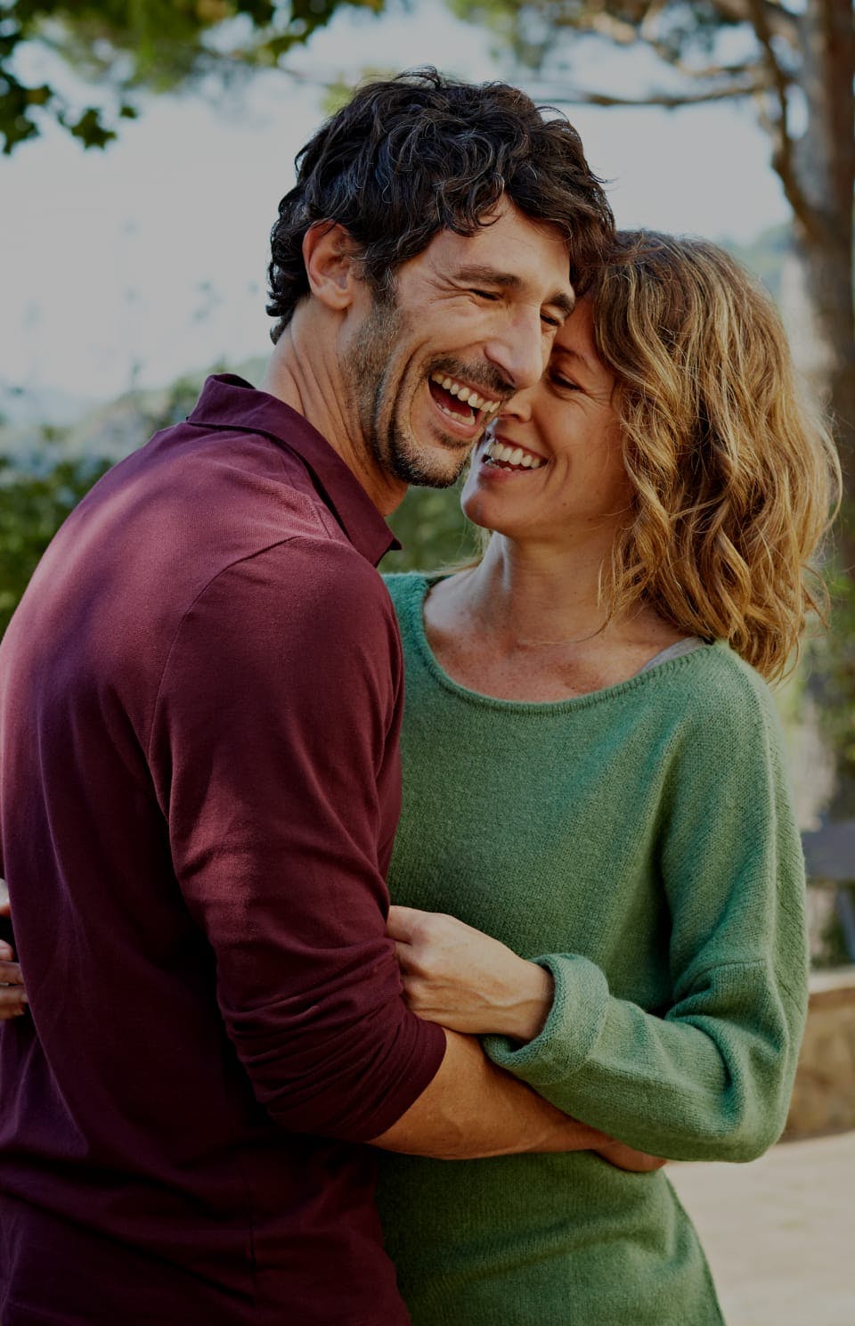 man and women embrace and smile