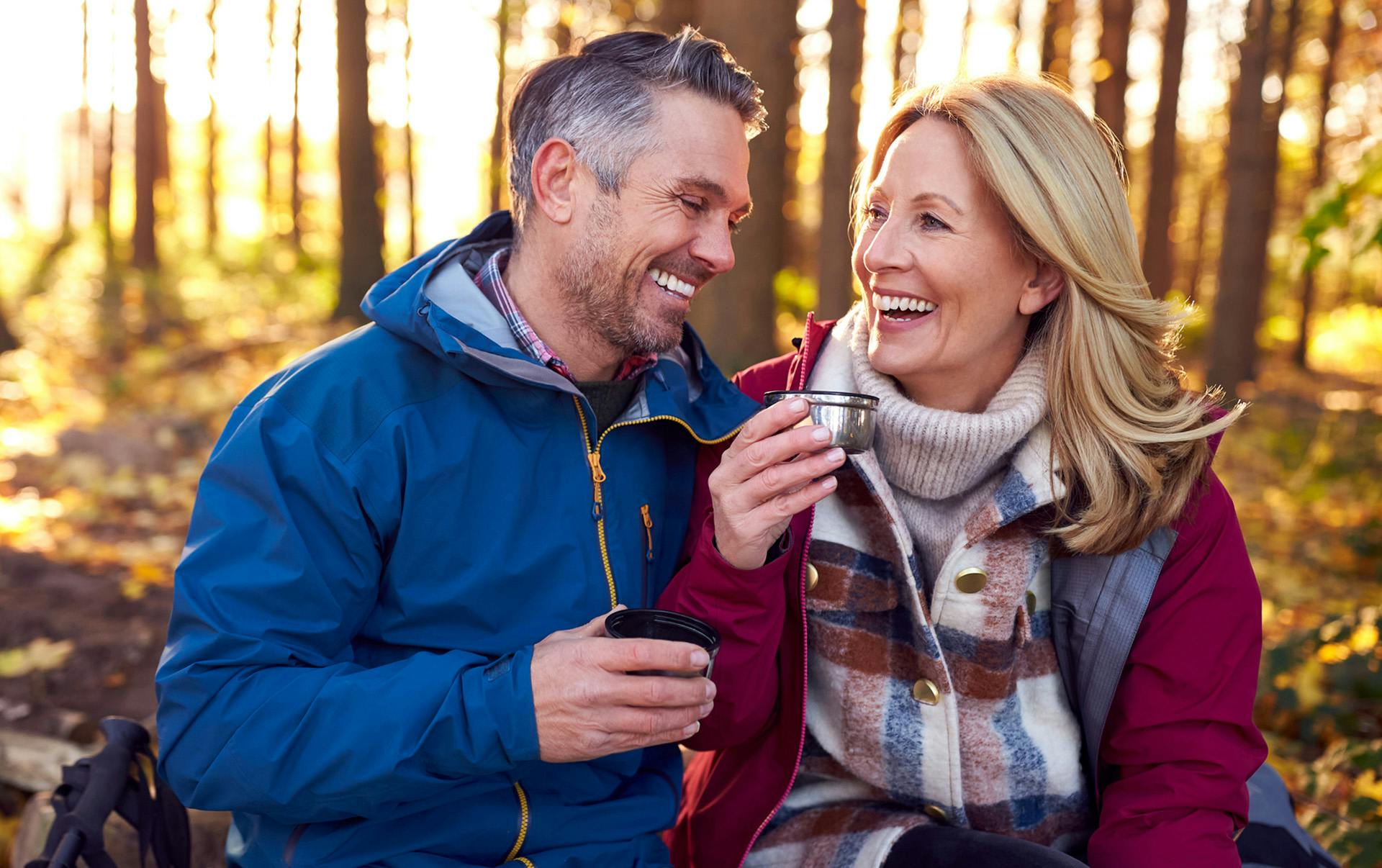 Couple enjoying tea on a winter hike.