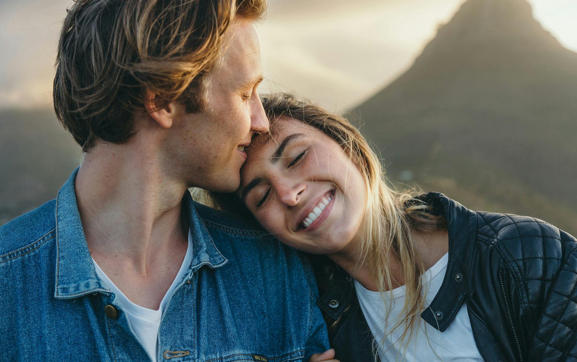 Woman resting head on man's shoulder.