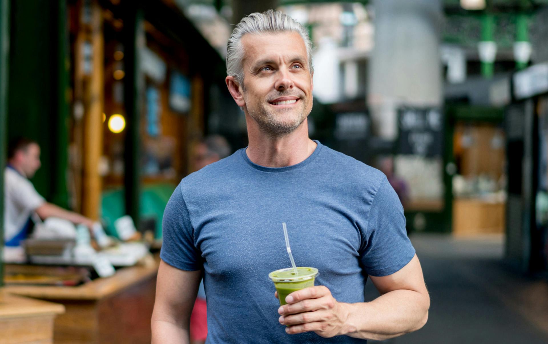 Smiling man drinking health drink.
