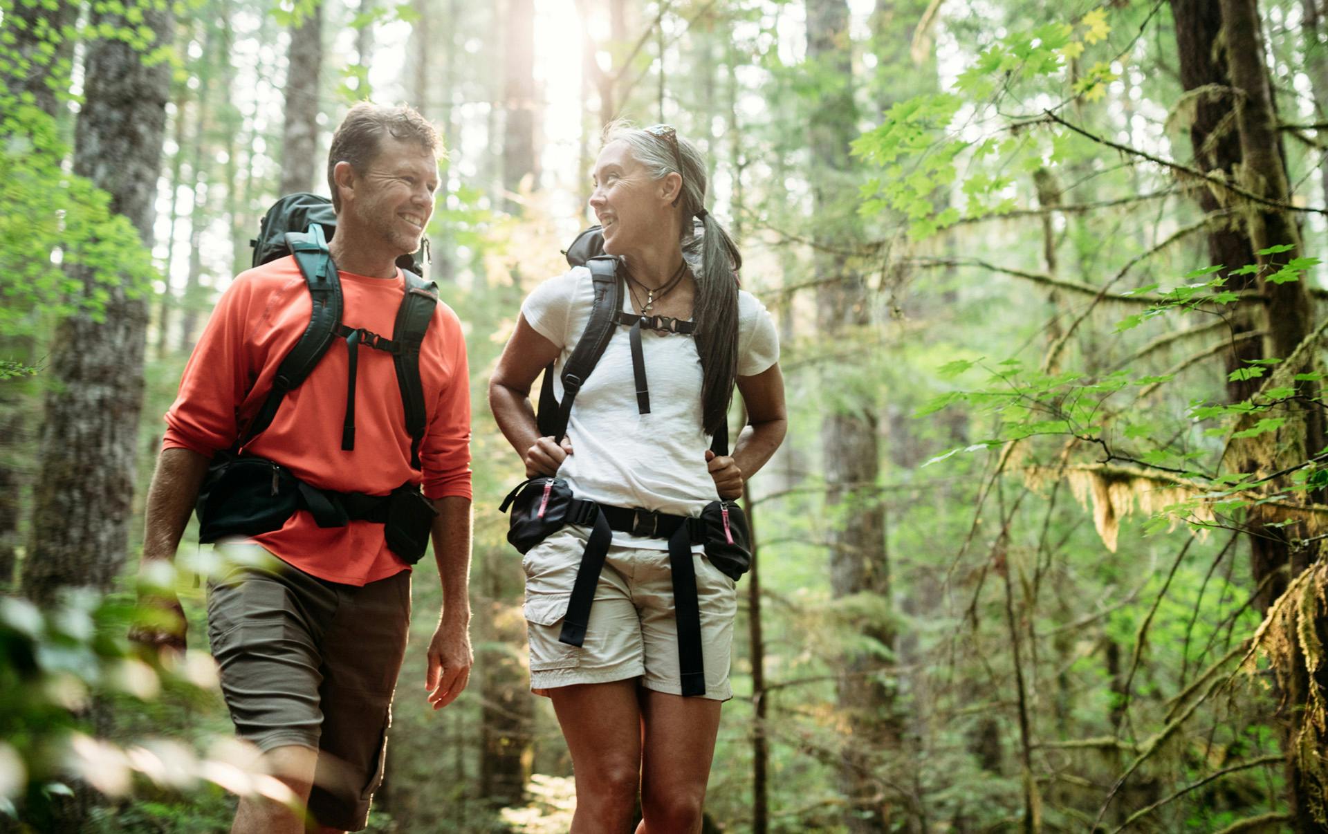 Two people on a hike in the woods.