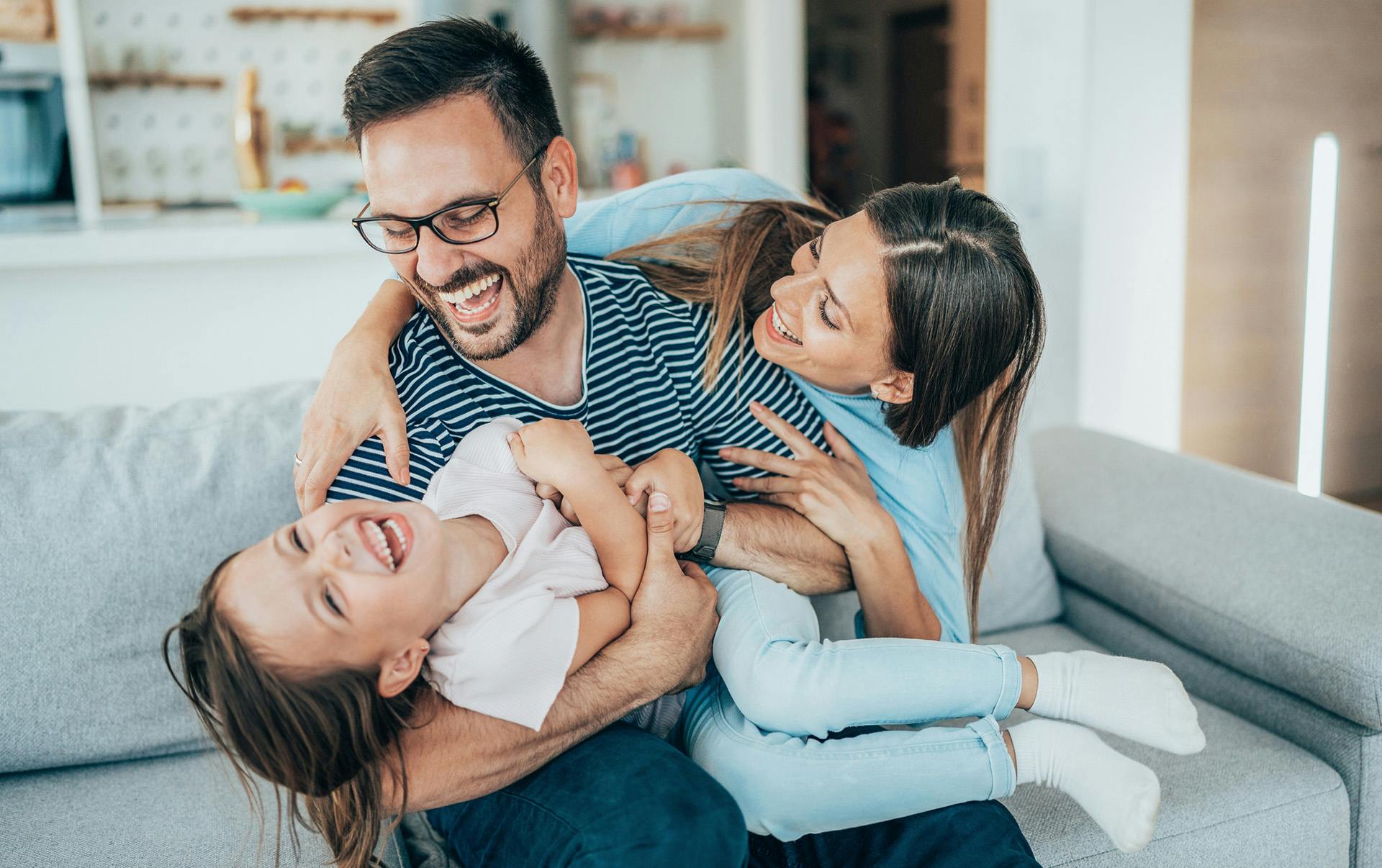 Family playing on couch.