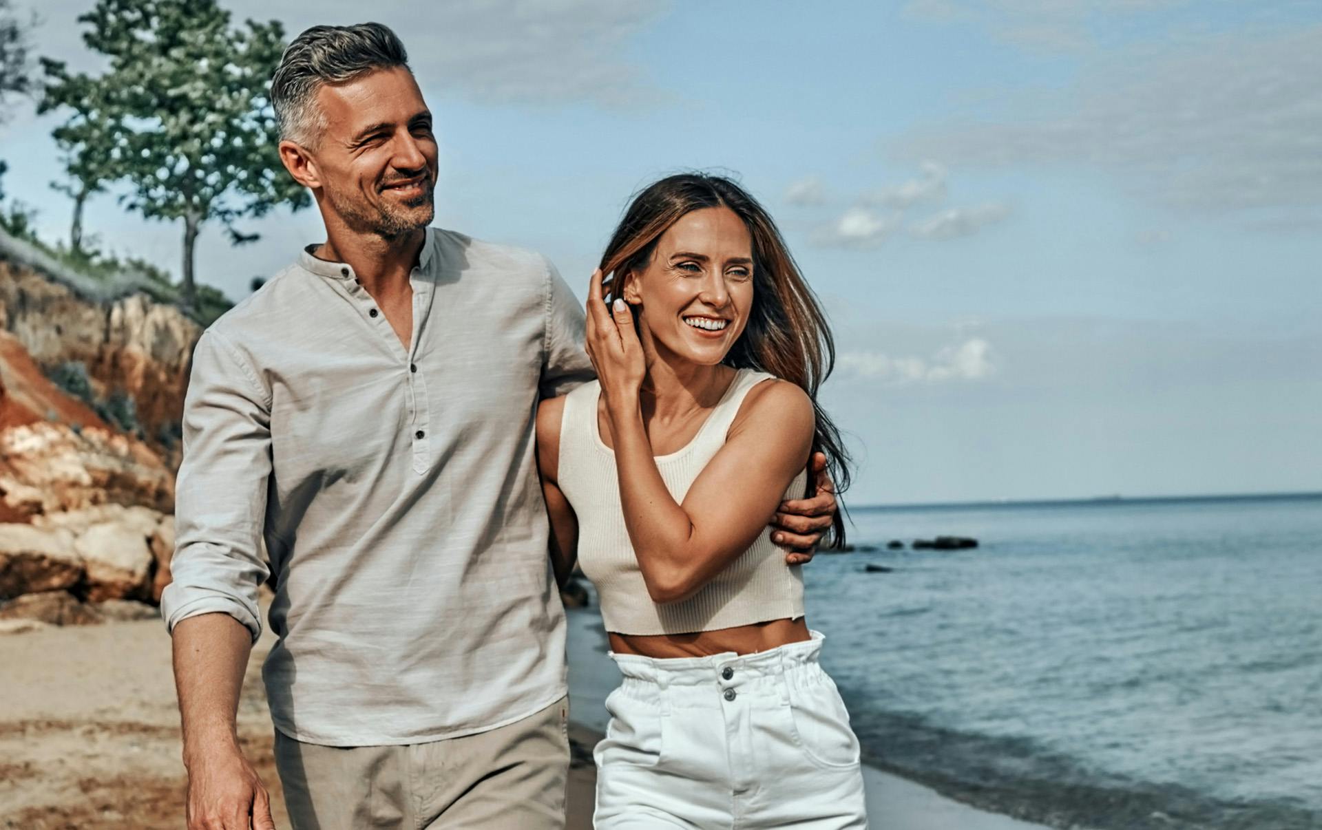 Couple walking on the beach.