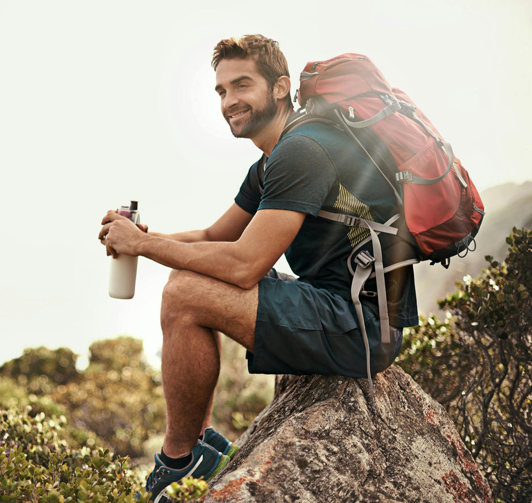 Man enjoying water on a hike.