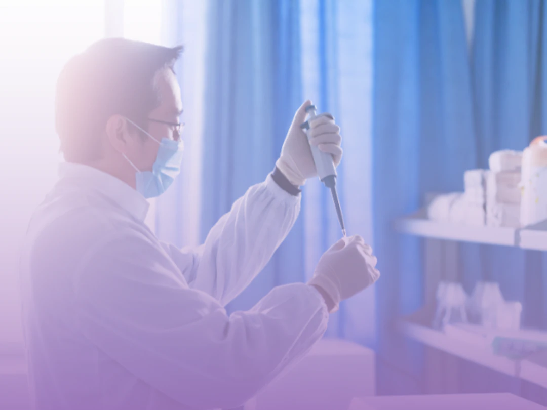 Picture of a scientist pipetting in purple haze.