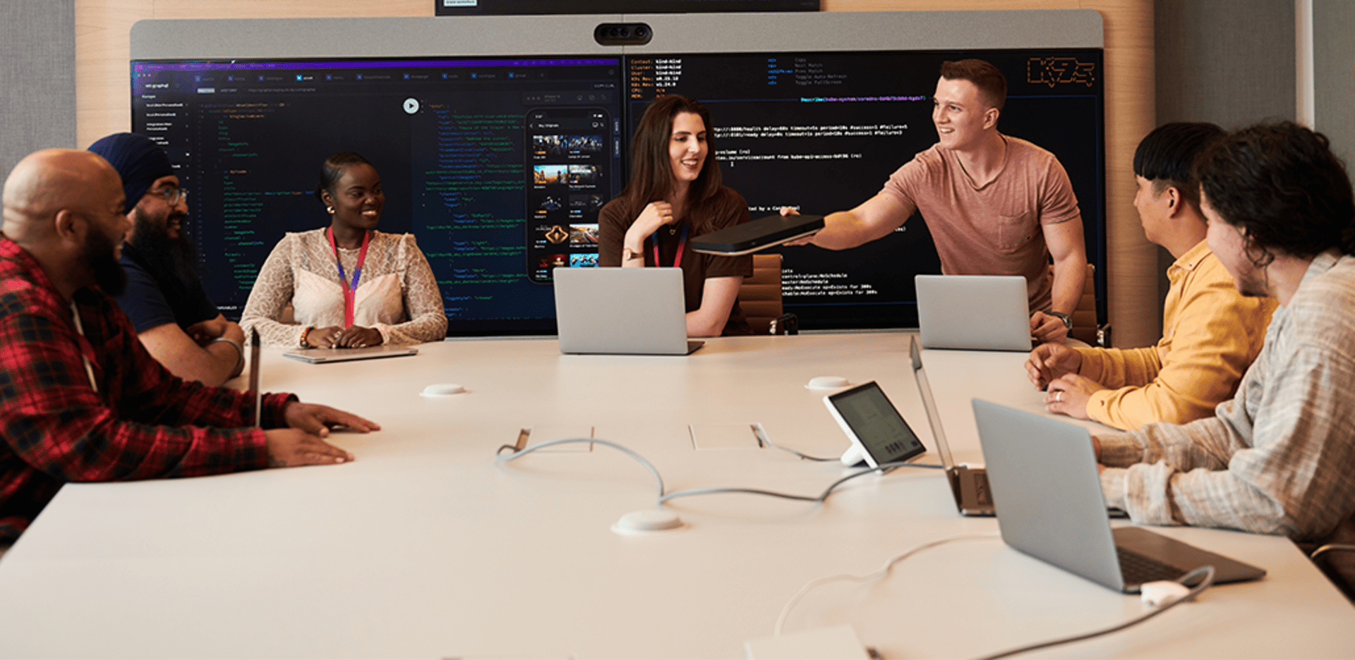 Group of people sat together coding.