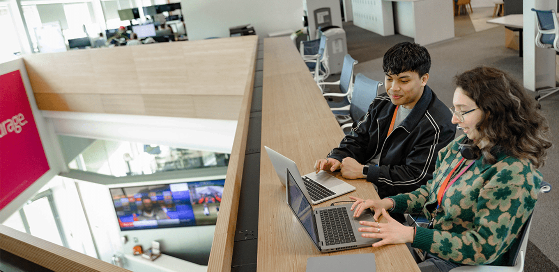 Two people concentrating on laptops.