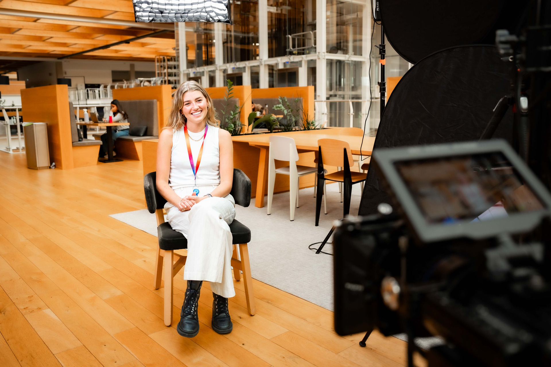 Girl sitting in front of camera crew.