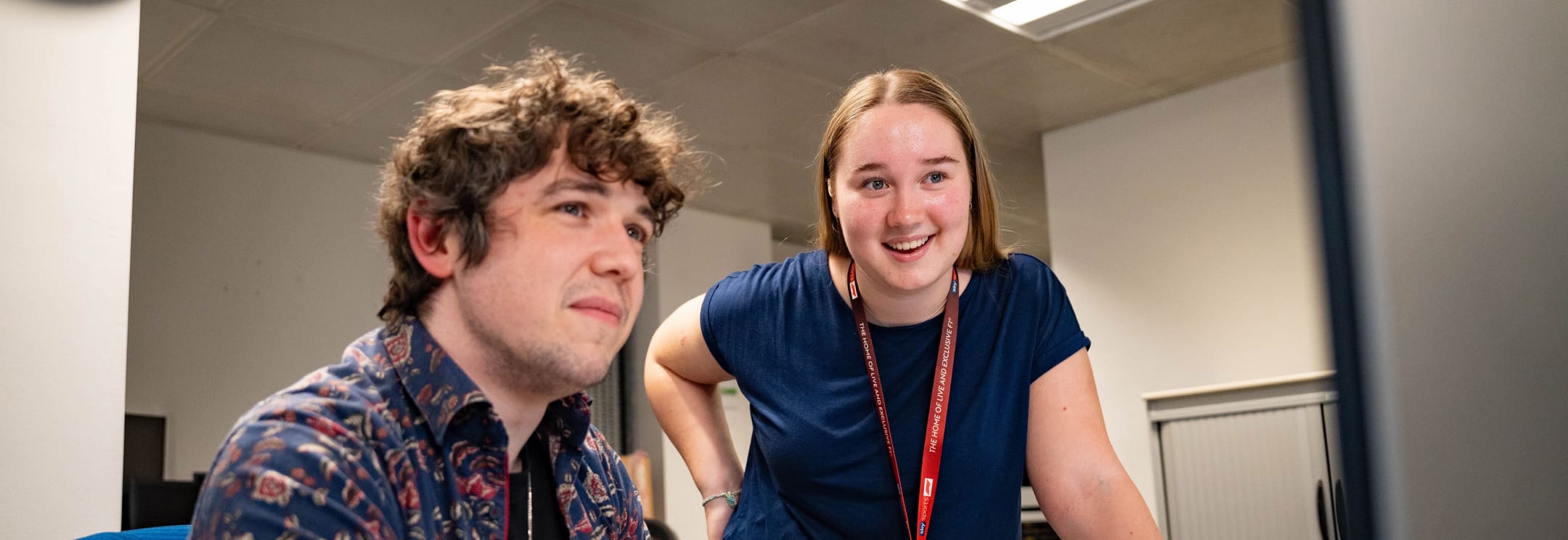 Two people looking at a computer