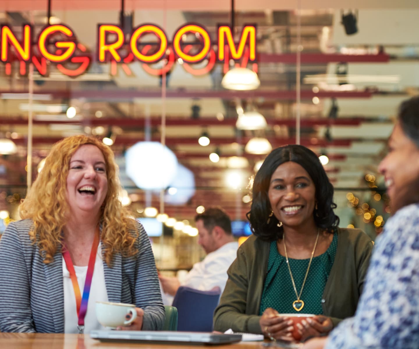 group of women laughing together at a table