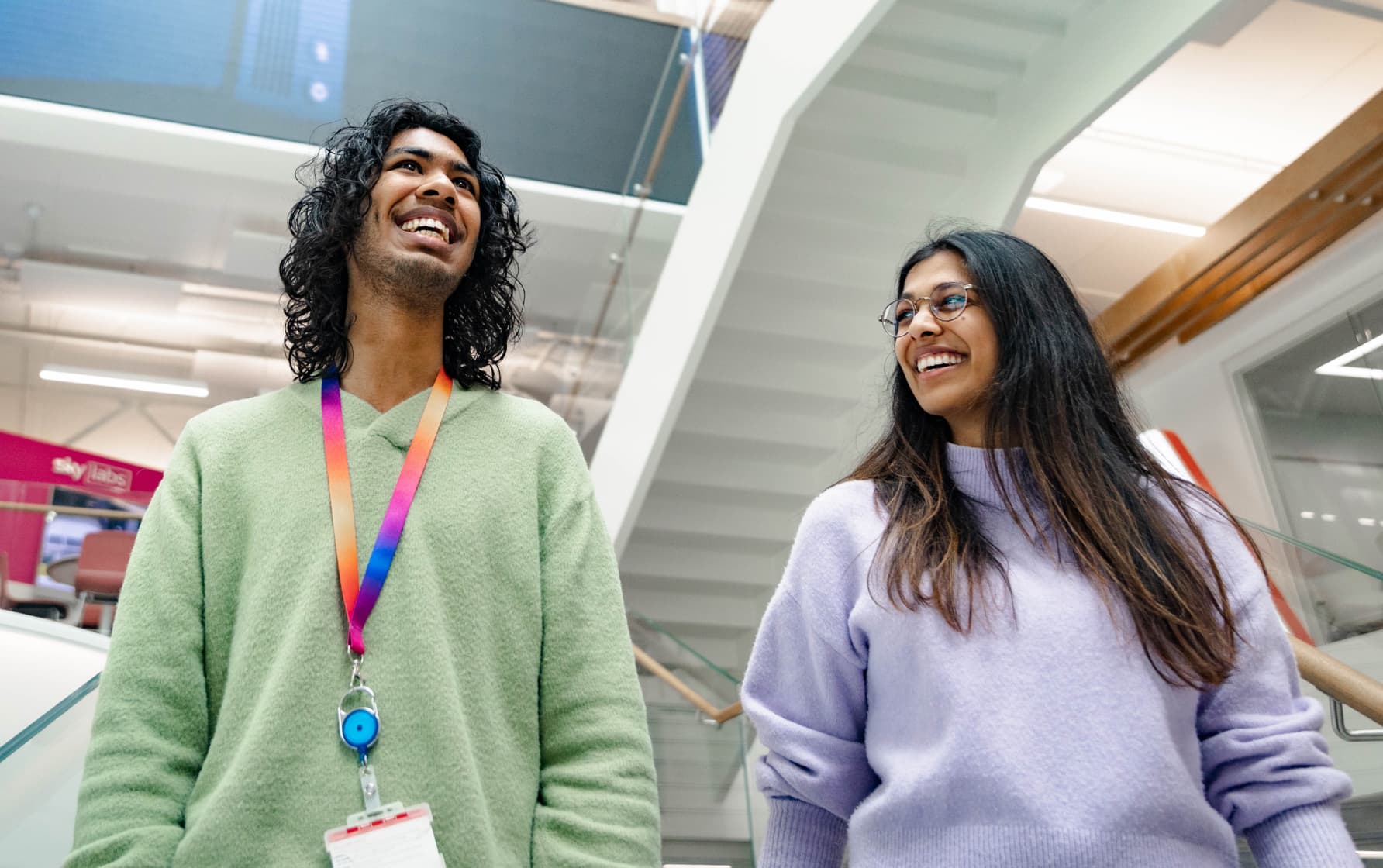 two people smiling whilst walking together