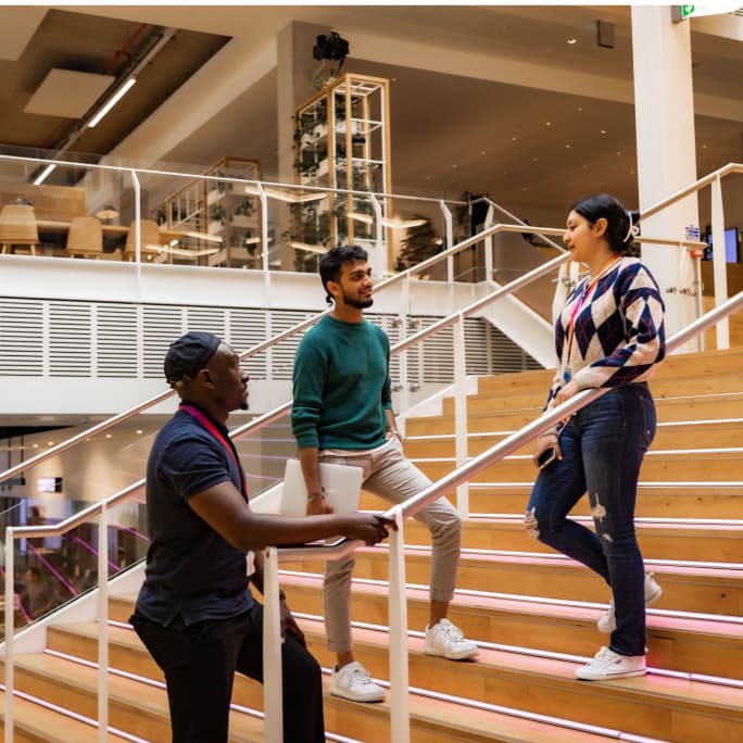 people standing in conversation on the stairs