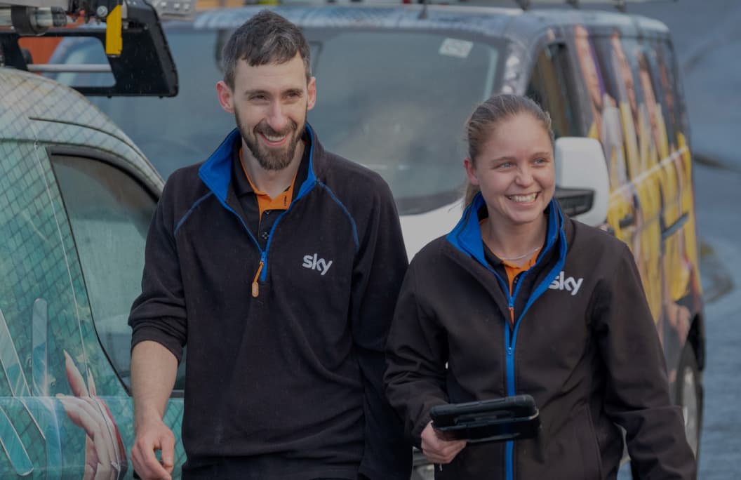 two people smiling whilst walking together