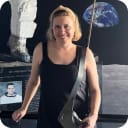 Image of a women stood in a TV station wearing a black t-shirt