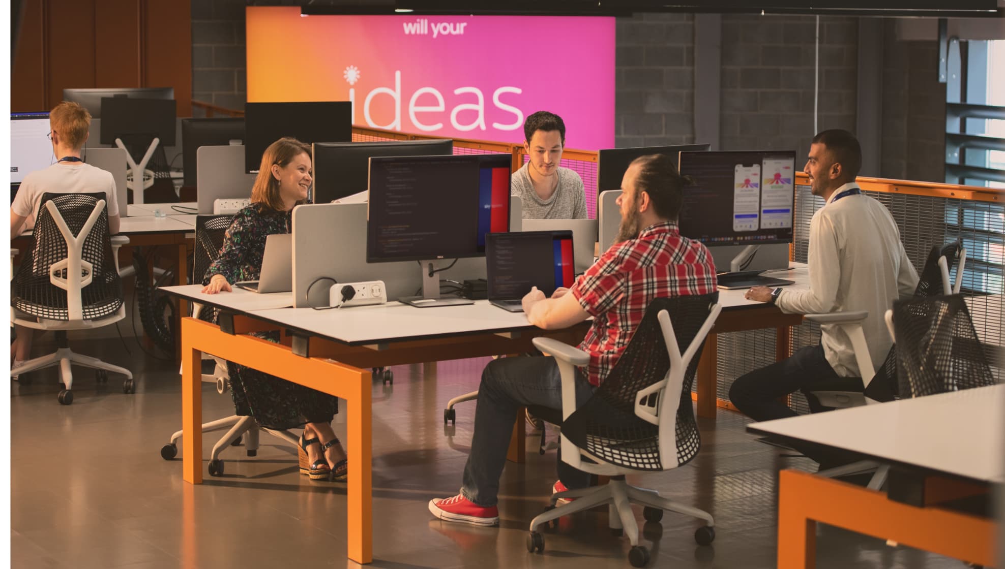 group of people working at their desks