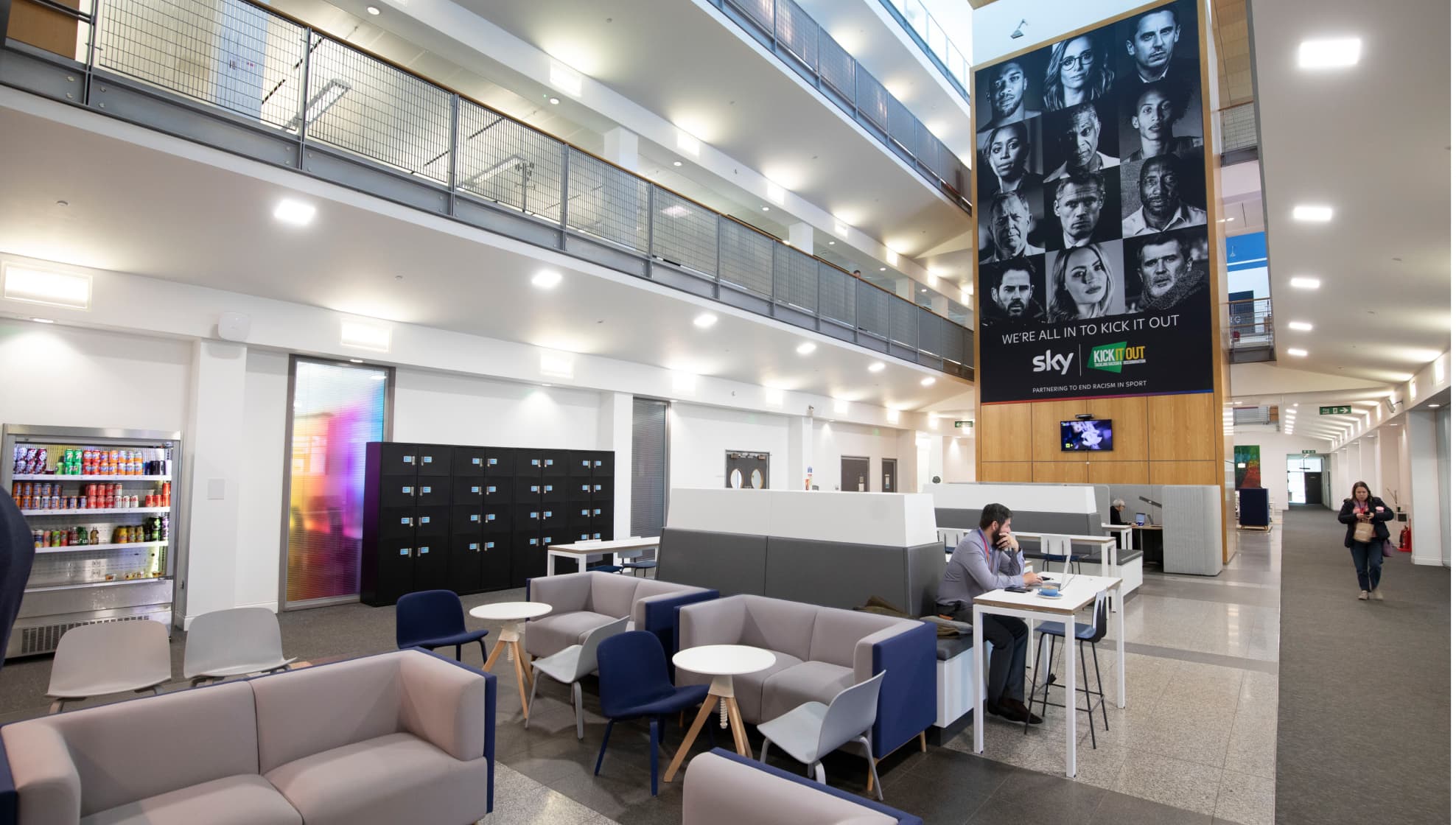 spacious office with comfortable chairs and Sky advert hanging above