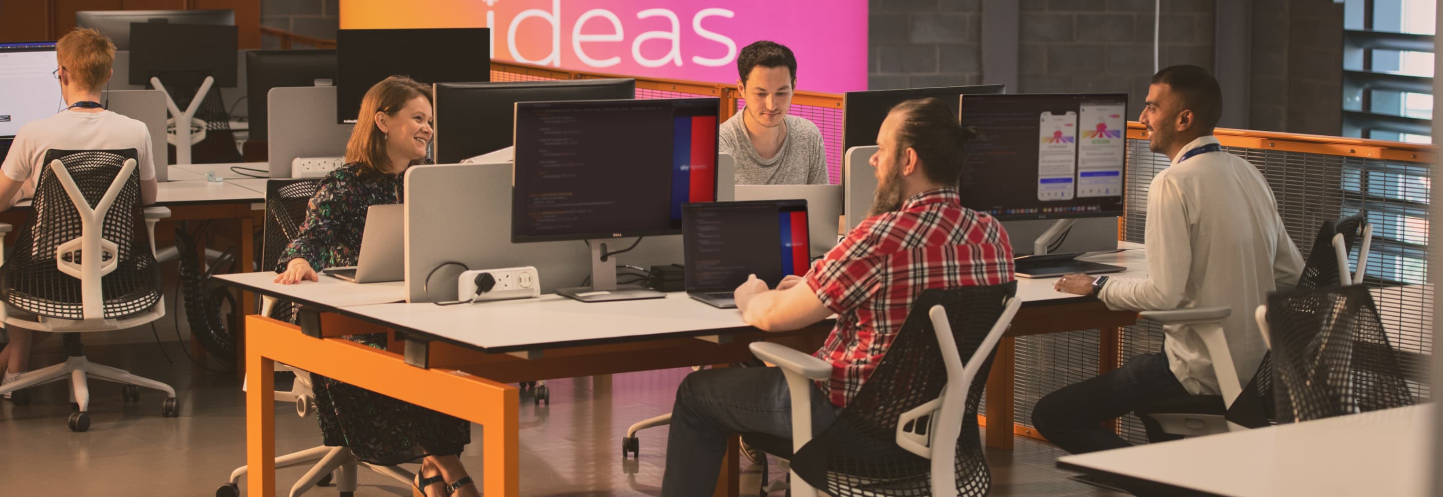 people working on computers at a desk