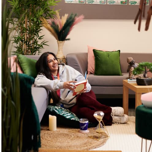 woman sitting on the floor reading a book