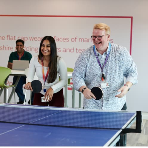 two people playing table tennis