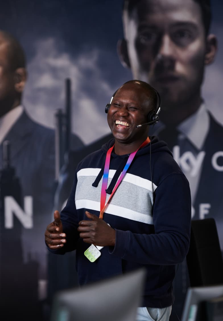 man standing up with a headset on smiling