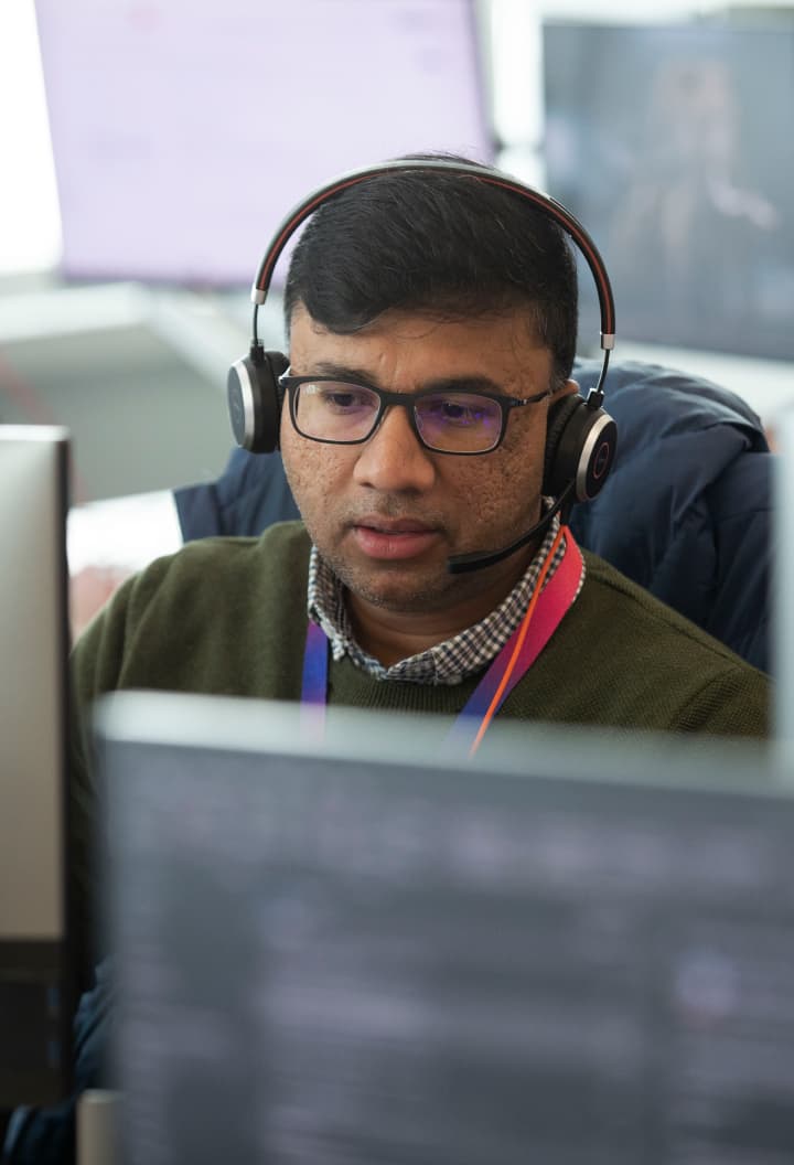 a man with glasses wearing a headset