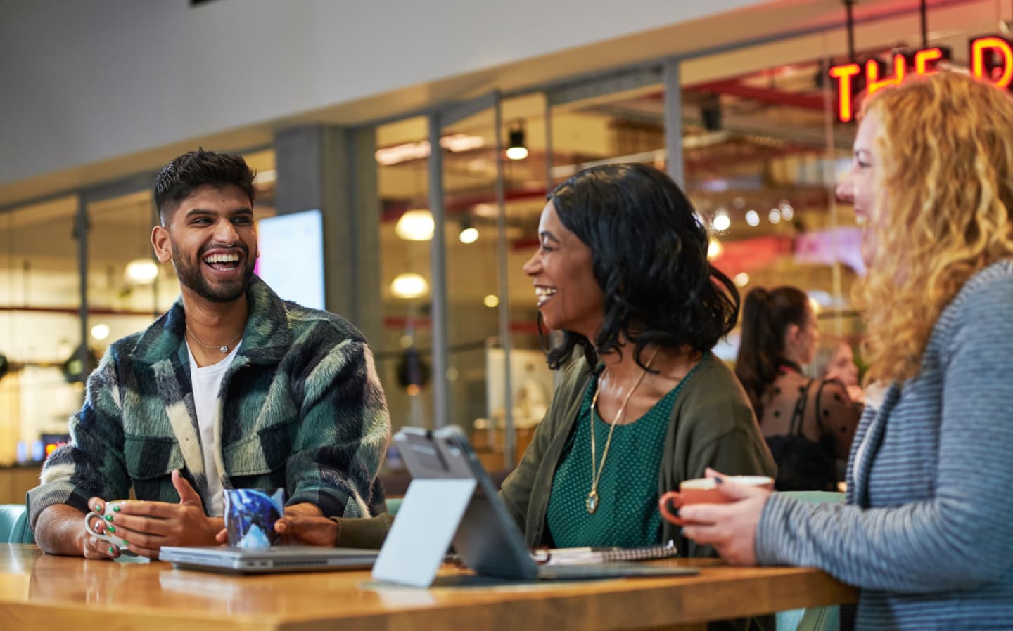 people laughing around a table