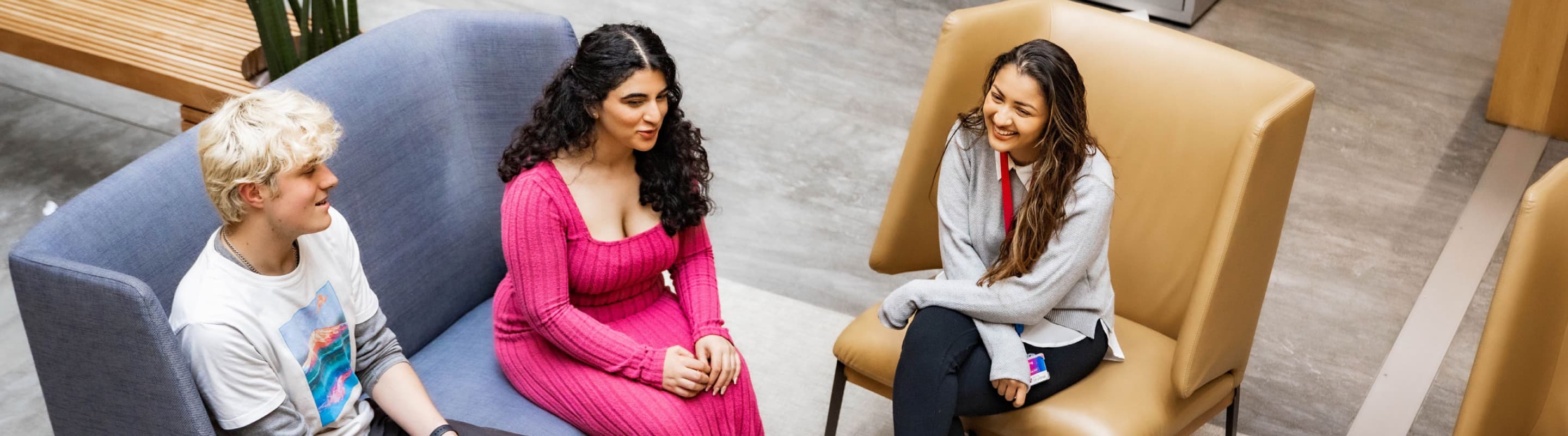 Group of people sitting on sofas smiling