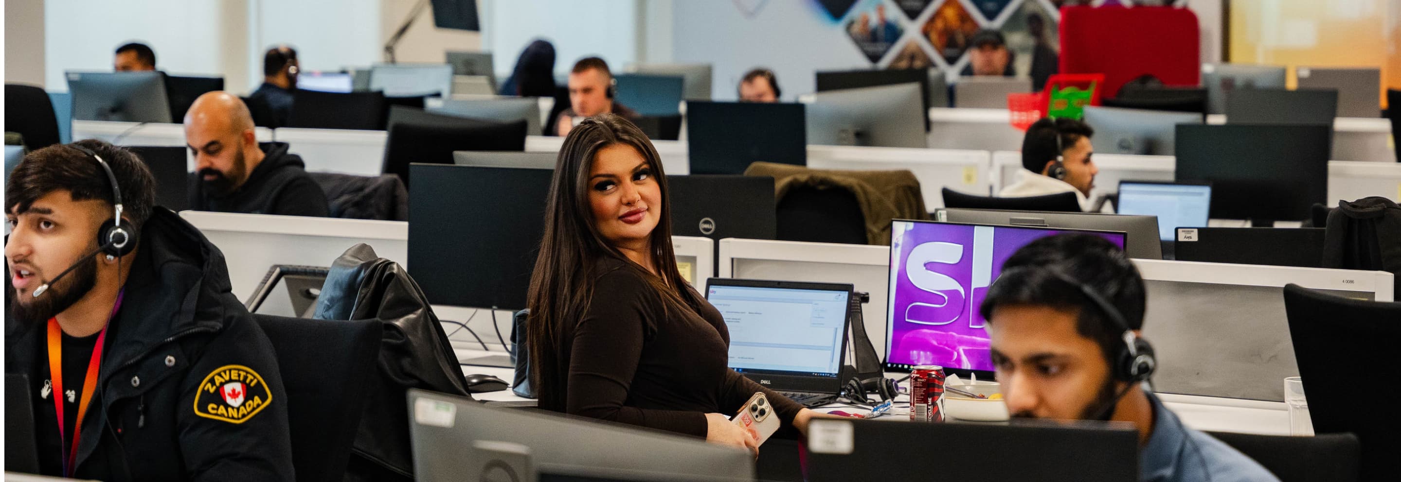 people in a call centre wearing headsets