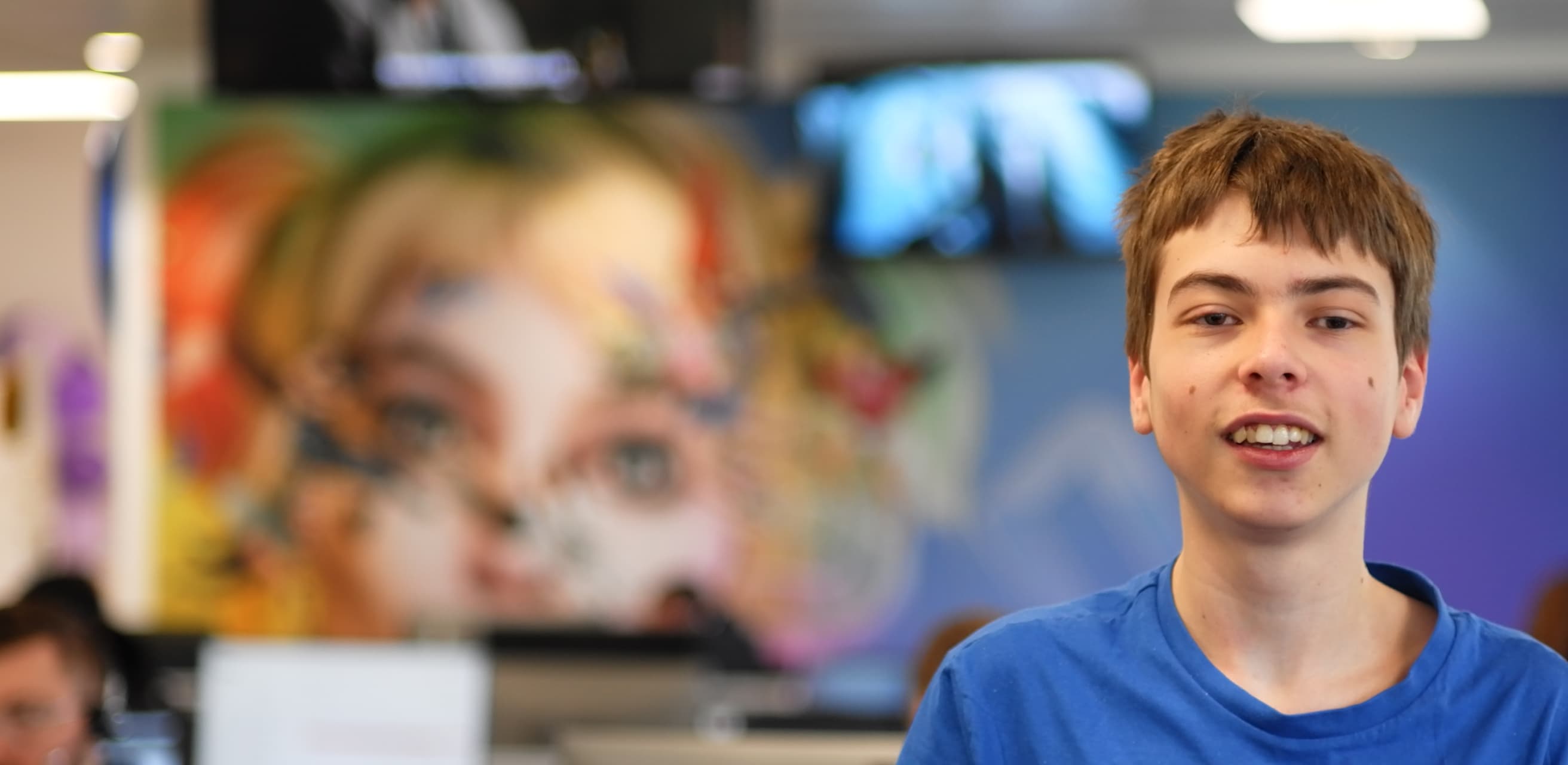 a young man wearing a blue t-shirt