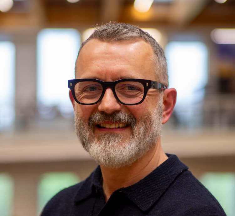 man in glasses with short grey hair and low cut grey beard