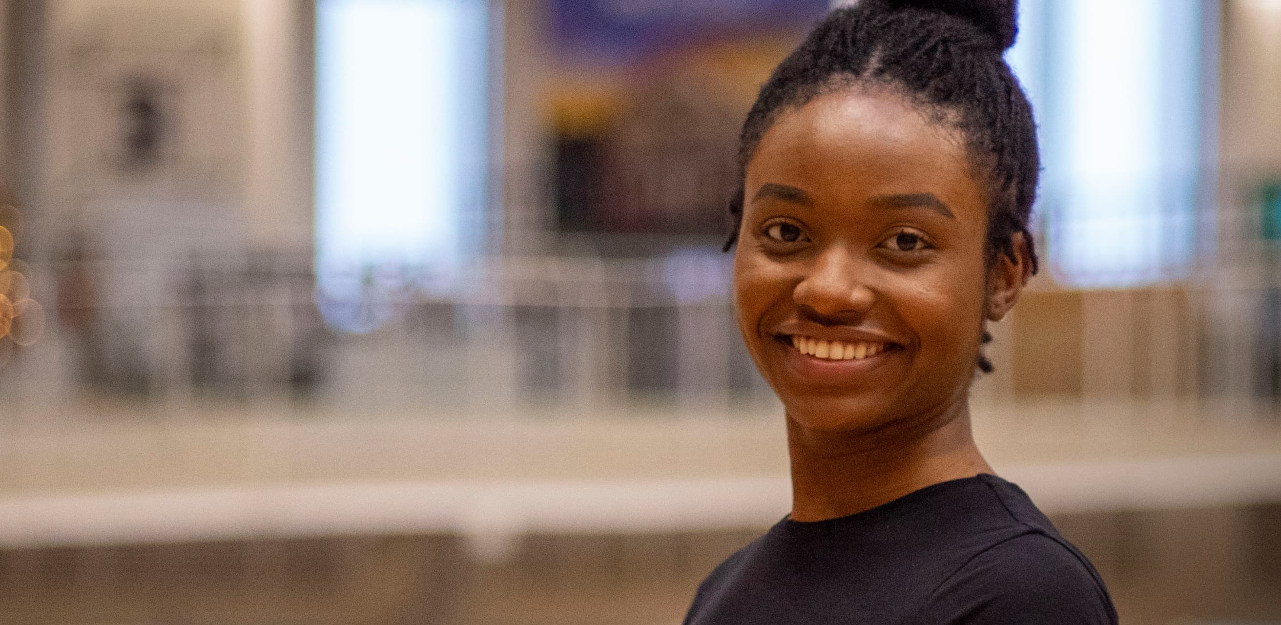 a smiling black woman with locs