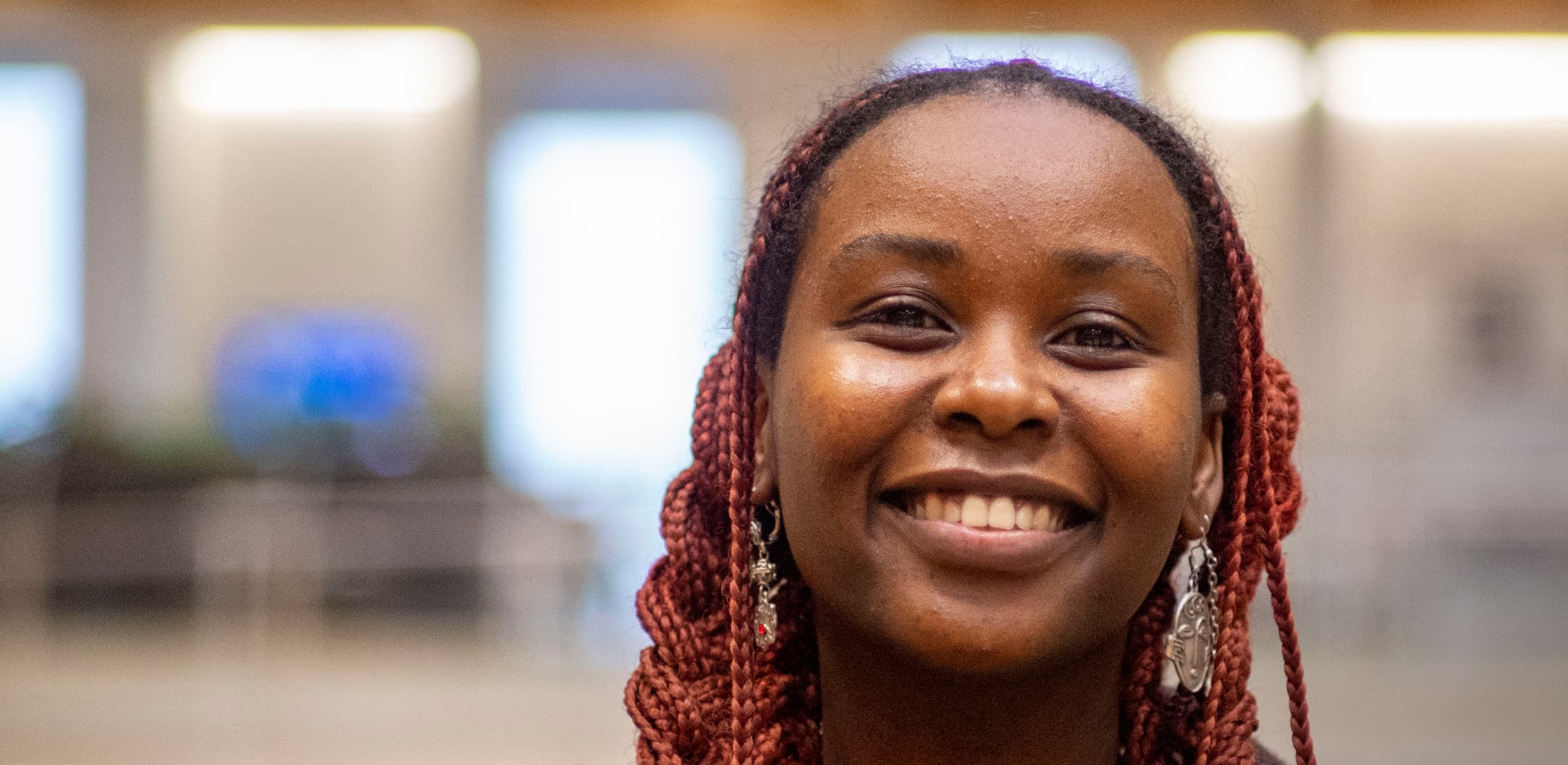 smiling black woman with long red braids