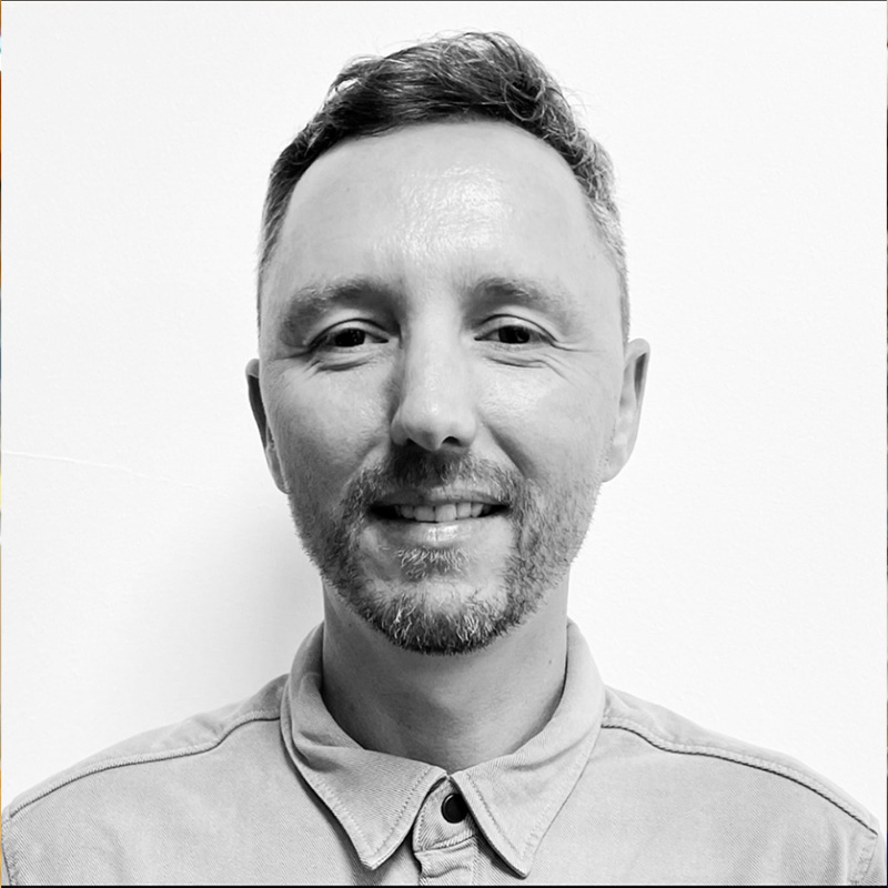 Guy looks into the camera for a profile picture. The background is plain white.
