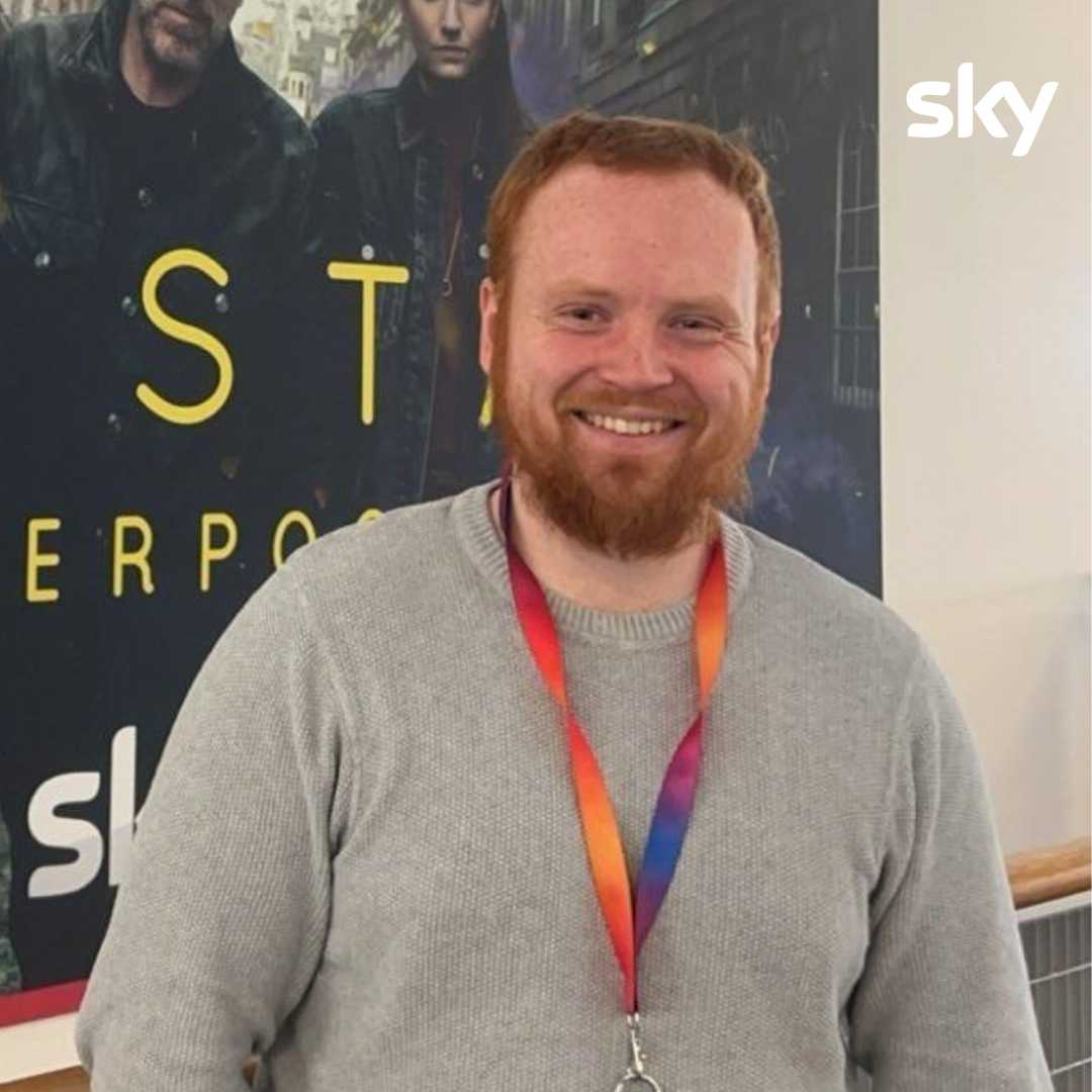 Sean smiling in a grey jumper