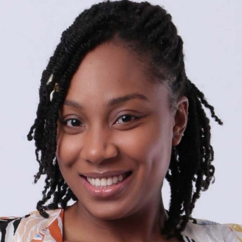 A profile of Malissa, standing in front of a white background.