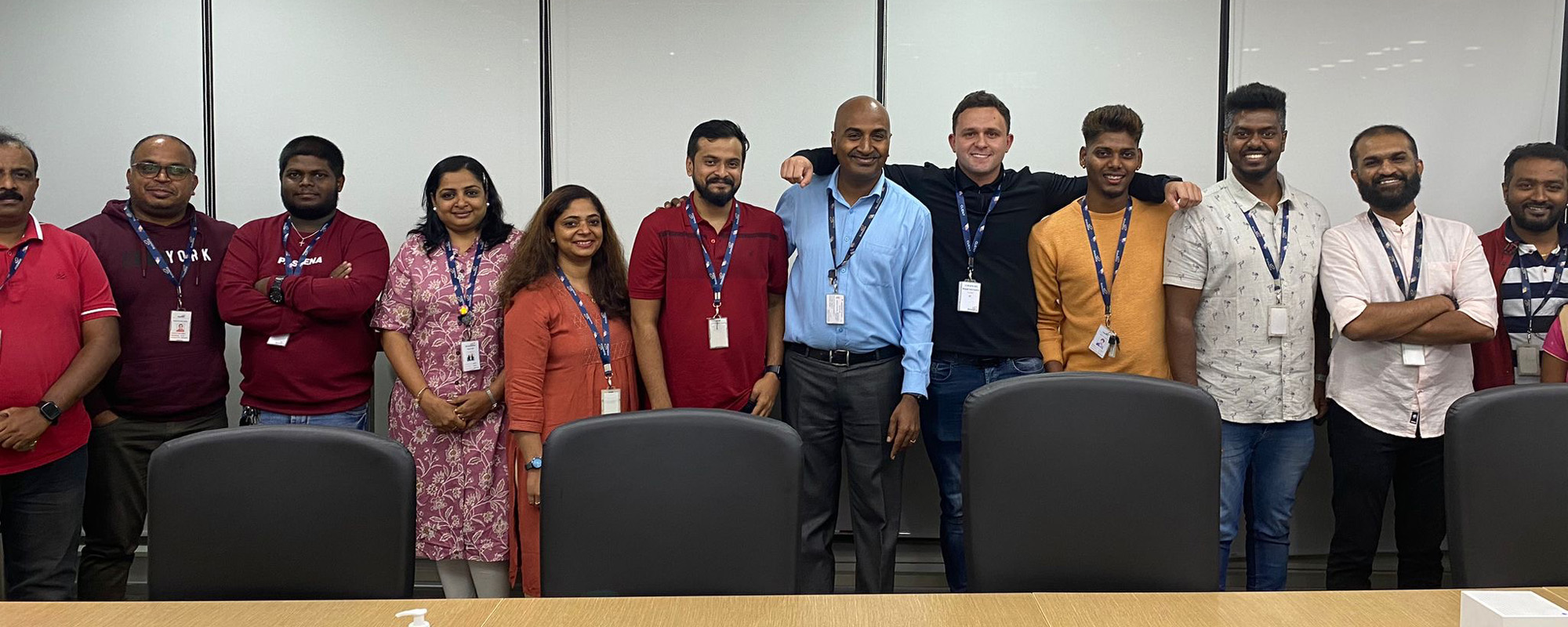 A team photo in a meeting room.
