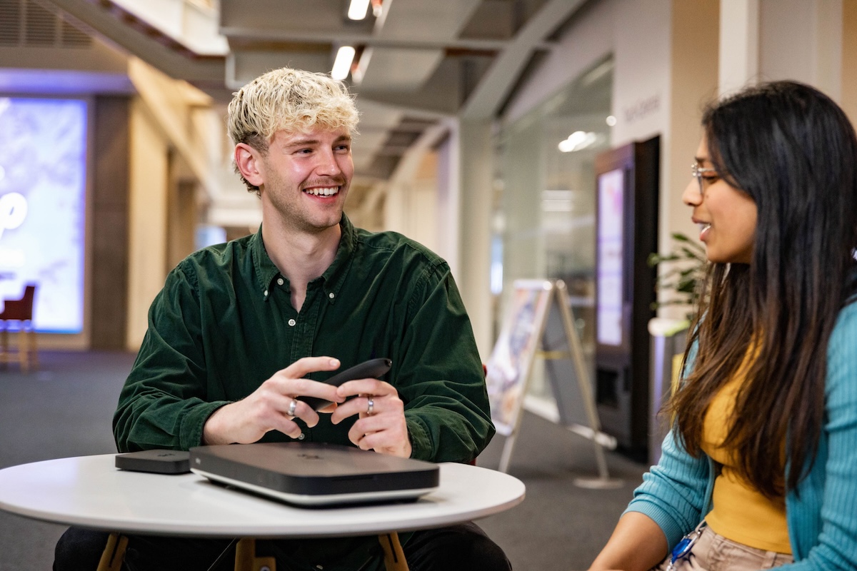 two people at a desk having a conversation