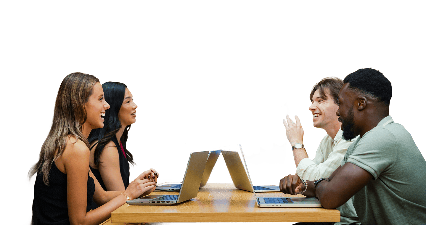 Four people sat with open laptops in an office booth