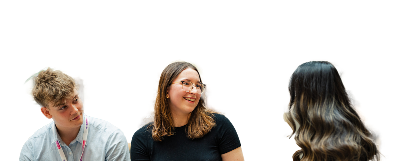 A group of three employees looking at one another and talking