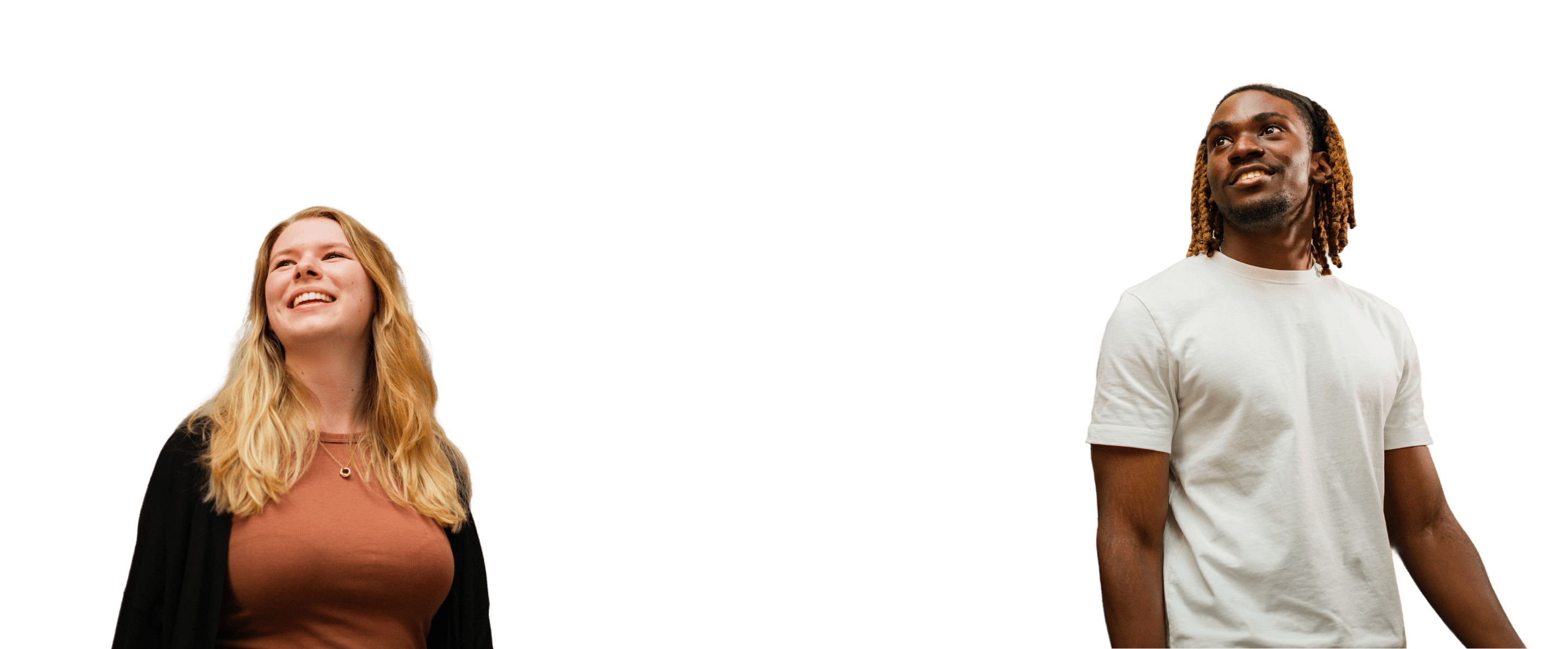 Two people smiling and looking upward, both casually dressed and isolated on a black background.