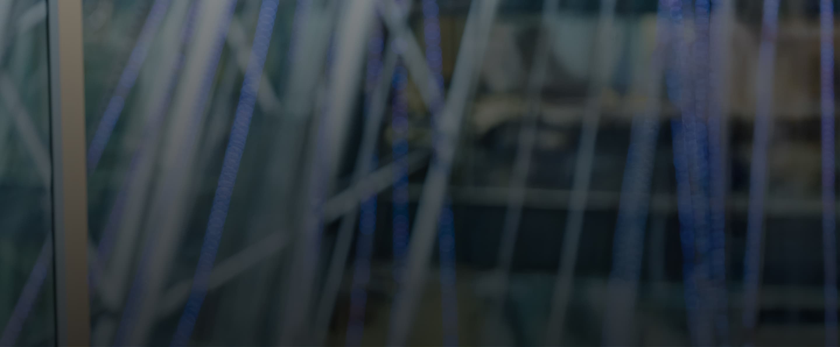 Abstract view of glass architecture with blue LED lights, softly blurred.