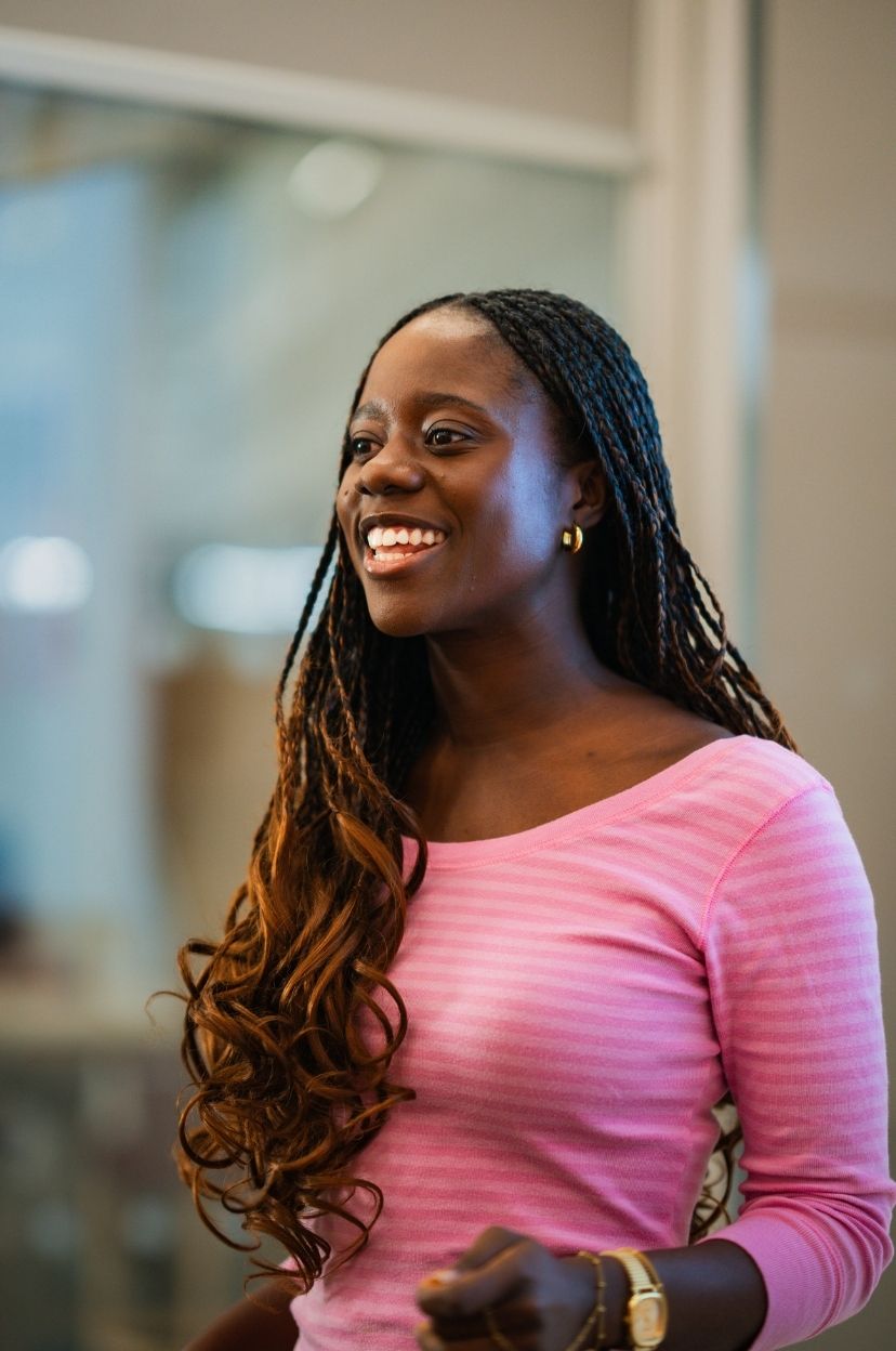 Smiling woman standing in a pink top