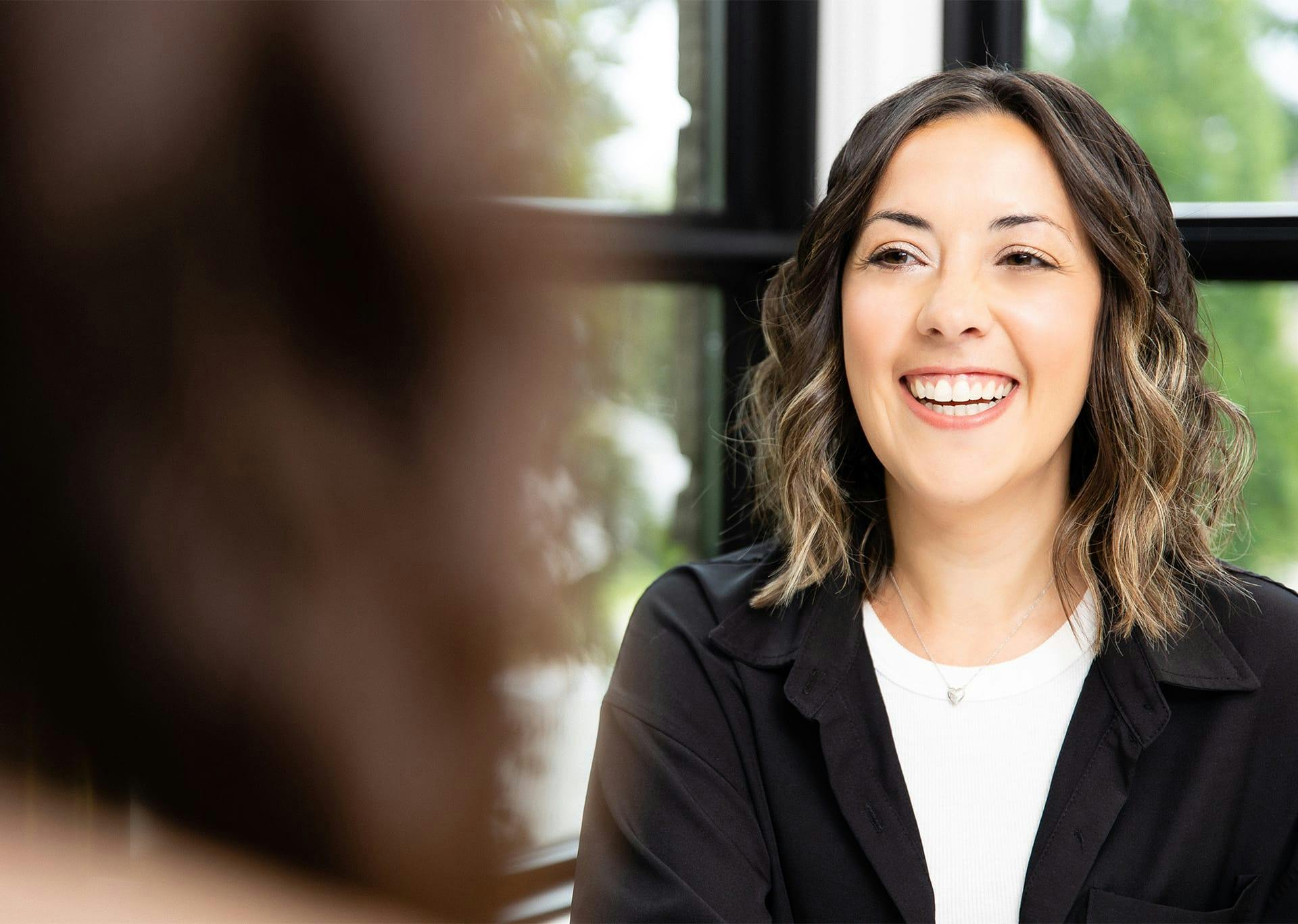 Patient smiling while speaking with nurse