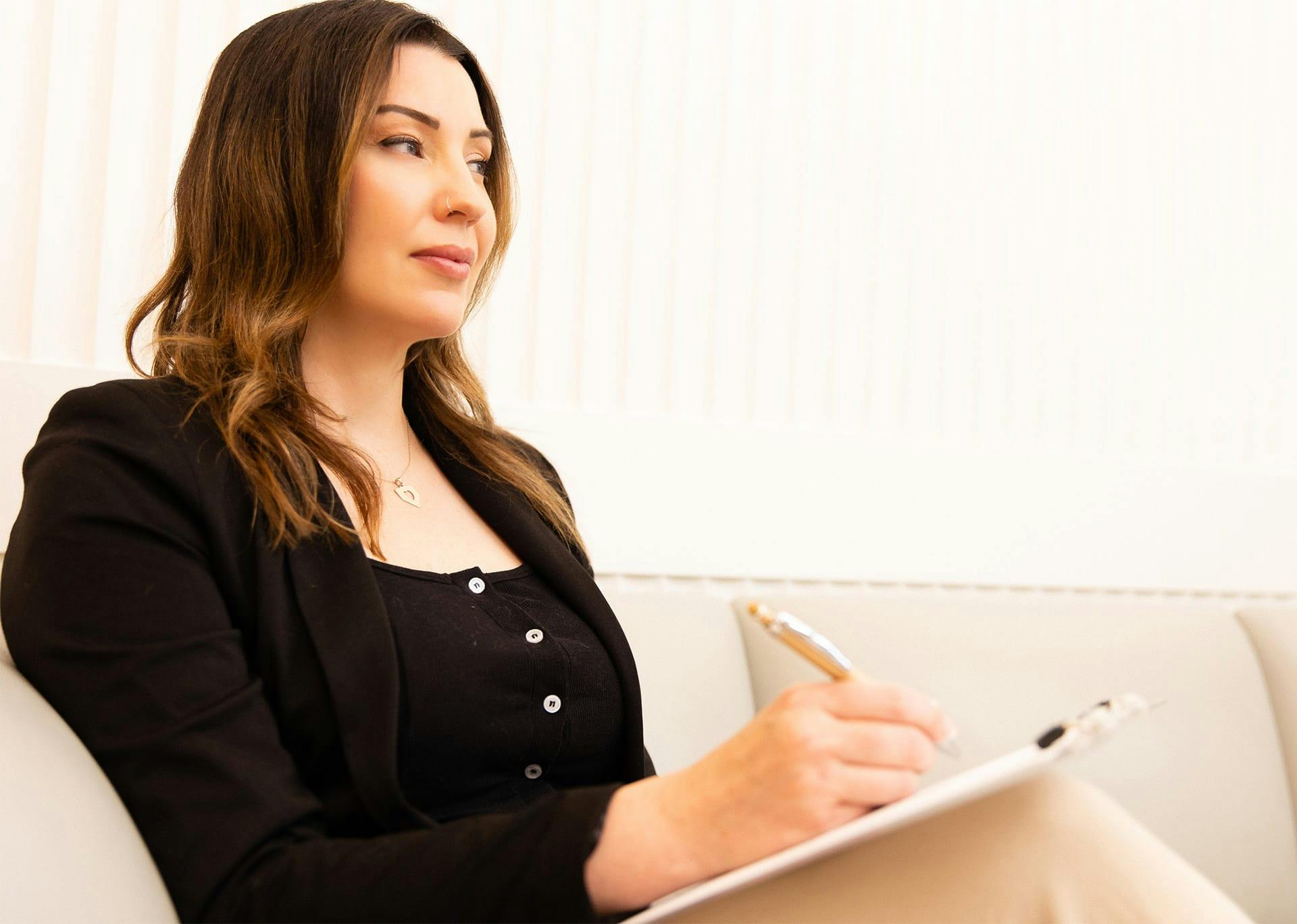 Woman writing on clipboard