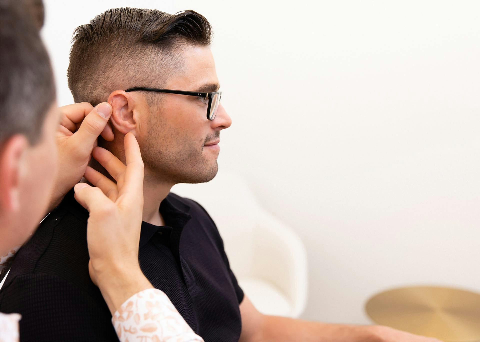 Dr. Brace examining Patient's ear