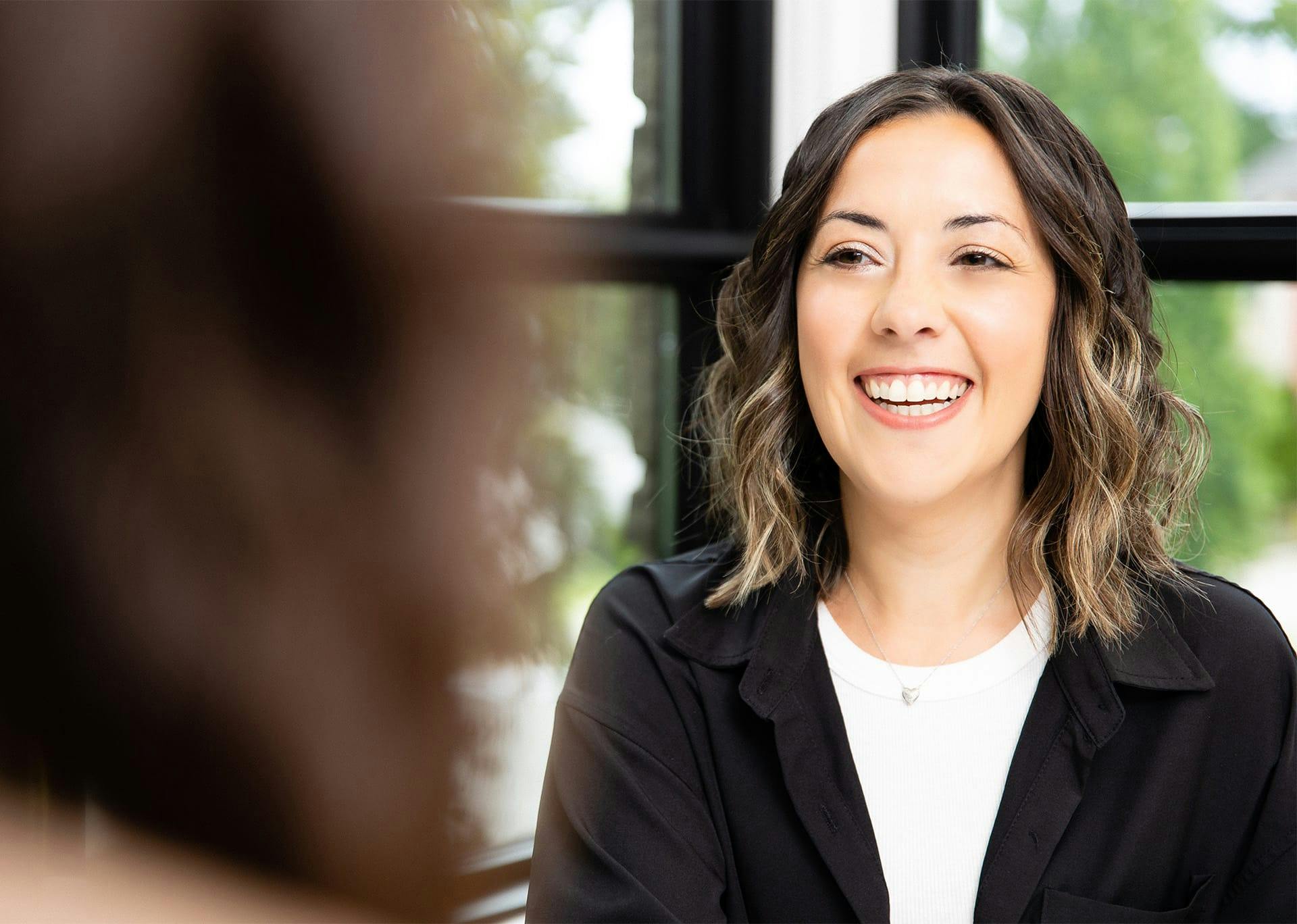 Patient smiling while speaking with Guelph Facial Plastics staff