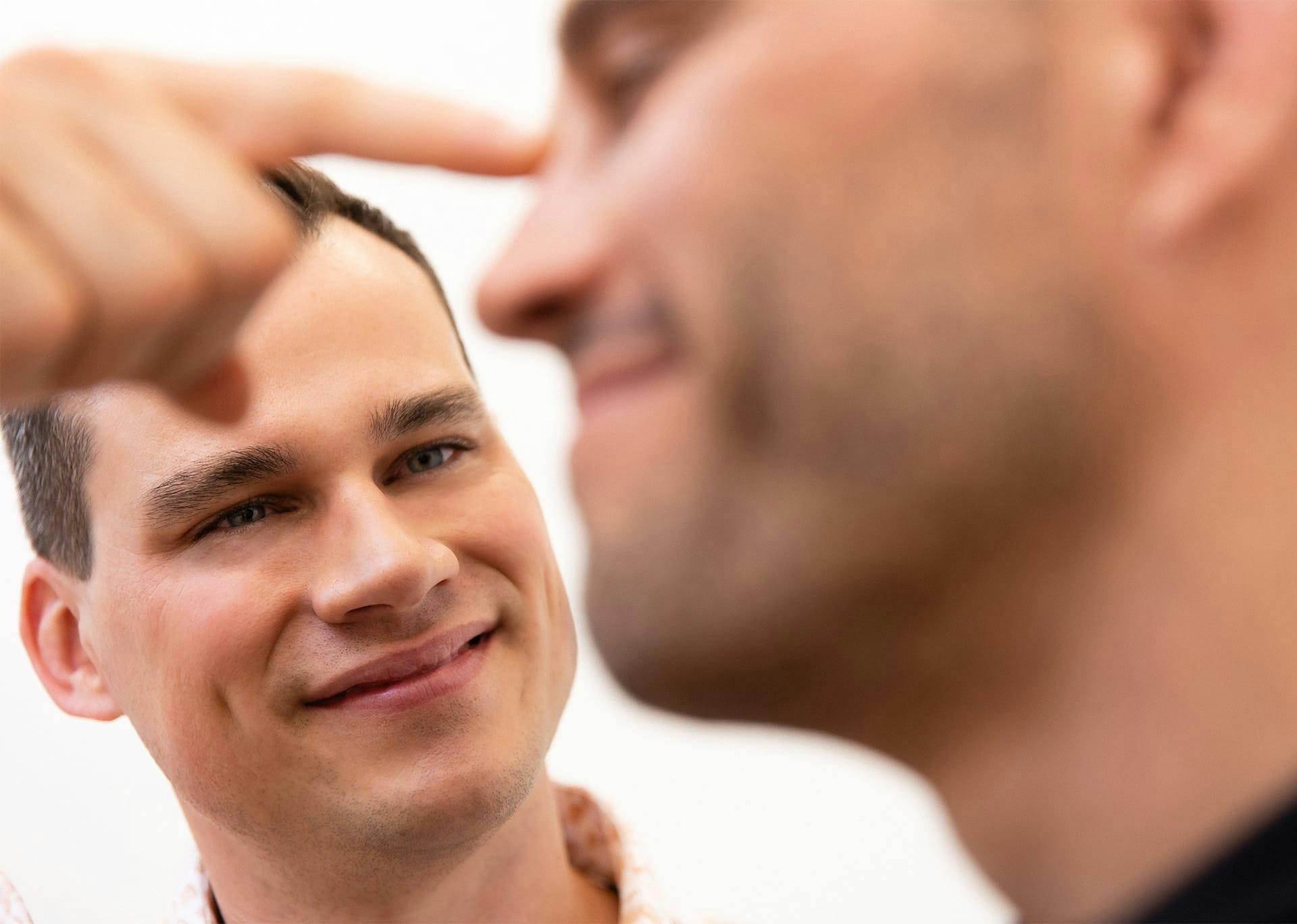 Dr. Brace examining patient's nose