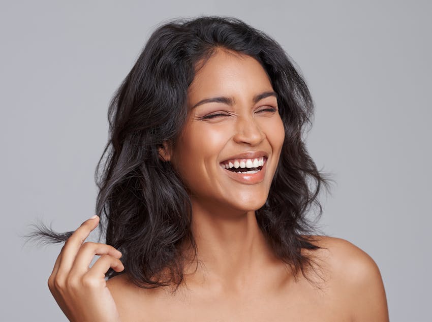 Model laughing and messing with hair