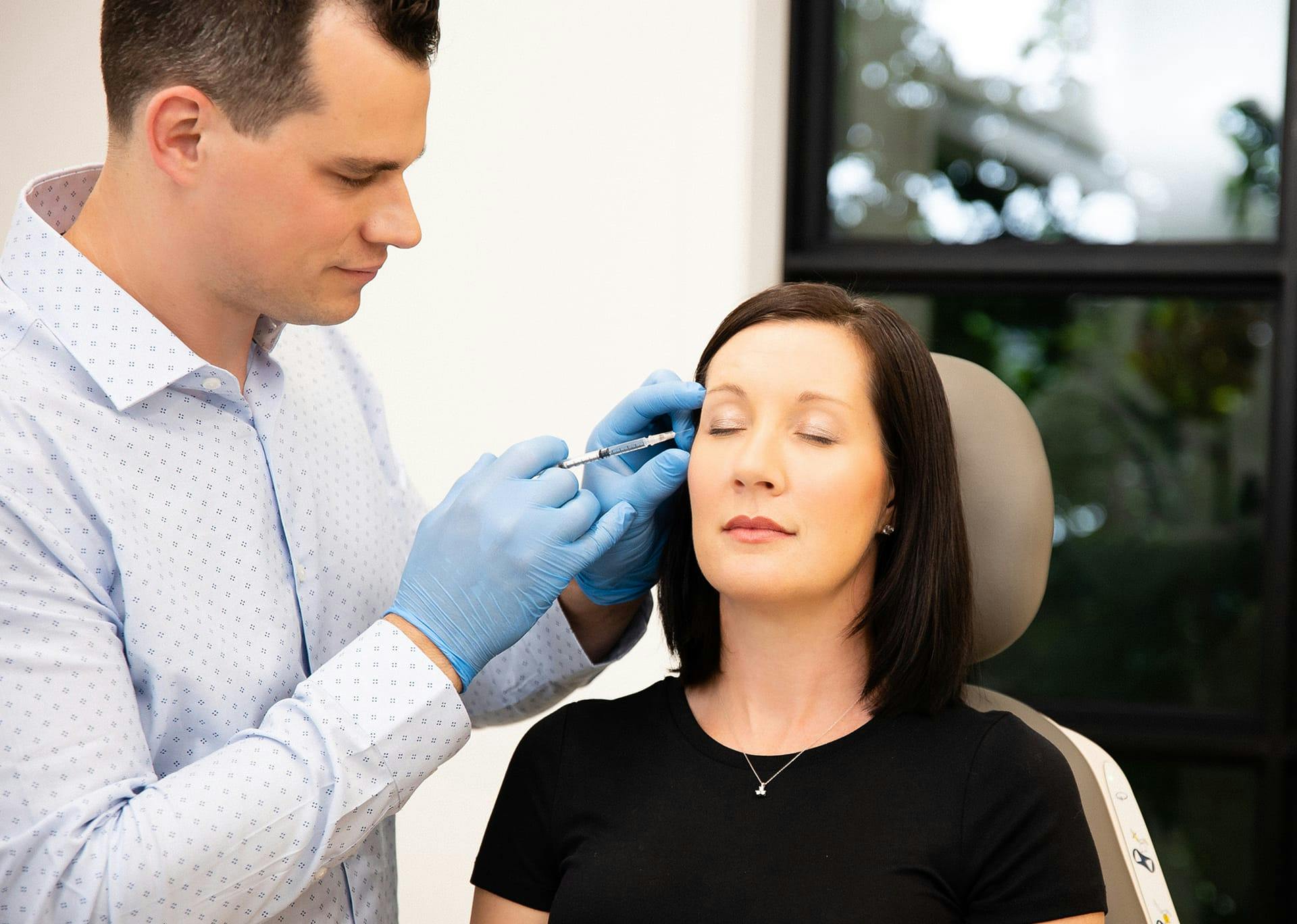 Dr. Brace applying BOTOX to patient