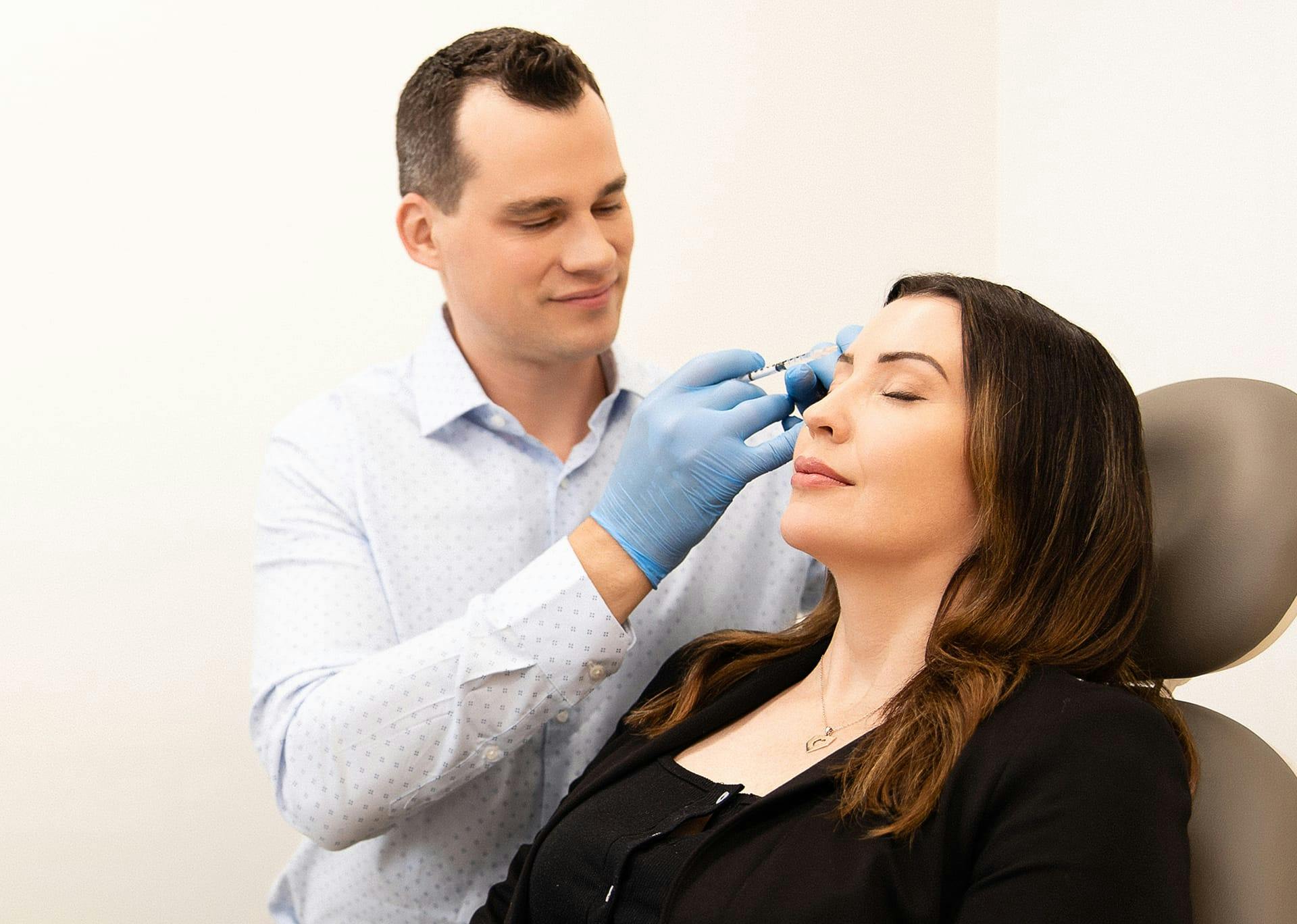 Dr. Brace Applying injectables to patient's forehead